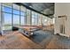 Modern game room with a billiard table and floor-to-ceiling windows offering cityscape views at 150 E Robinson St # 219, Orlando, FL 32801
