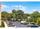 View of the parking lot with tree lined parking and blue sky at 150 E Robinson St # 219, Orlando, FL 32801