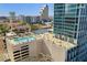 Rooftop featuring a swimming pool and recreational area for residents, with city views at 150 E Robinson St # 219, Orlando, FL 32801