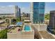 Urban rooftop pool and tennis court offering panoramic city views from a luxury residence at 150 E Robinson St # 219, Orlando, FL 32801