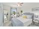 Light-filled bedroom featuring a gray headboard bed, modern furnishings, and a window shelf for decor at 1565 Leaf Ln, Kissimmee, FL 34744