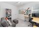 Bedroom features a gray couch, built-in shelving and a desk at 1565 Leaf Ln, Kissimmee, FL 34744