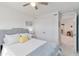 Bright bedroom featuring a gray headboard, a ceiling fan and a closet with double doors at 1565 Leaf Ln, Kissimmee, FL 34744