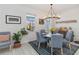 Cozy dining area featuring pendant lighting, blue velvet chairs, and a large window at 1565 Leaf Ln, Kissimmee, FL 34744