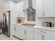 Kitchen features stainless steel appliances, white cabinetry, and an electric cooktop at 1565 Leaf Ln, Kissimmee, FL 34744