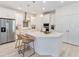 Bright kitchen features a large island, stainless steel appliances, and white cabinetry at 1565 Leaf Ln, Kissimmee, FL 34744