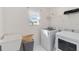 Practical laundry room with modern washer, dryer and sink, maximizing space and convenience at 1565 Leaf Ln, Kissimmee, FL 34744