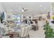 Airy living room with a ceiling fan and sliding glass doors to the pool and lanai at 1565 Leaf Ln, Kissimmee, FL 34744