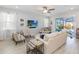 Comfortable living room filled with natural light, overlooking the screened lanai and pool at 1565 Leaf Ln, Kissimmee, FL 34744