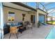 Charming outdoor patio with stylish seating, ideal for relaxing by the beautiful pool area at 1565 Leaf Ln, Kissimmee, FL 34744