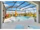Inviting screened pool with in-water seating, perfect for relaxation and entertaining in style at 1565 Leaf Ln, Kissimmee, FL 34744