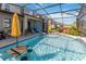Stunning screened pool featuring sun umbrellas and clear water for ultimate backyard enjoyment at 1565 Leaf Ln, Kissimmee, FL 34744