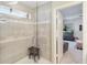 Walk-in shower with gray tiling and glass door, adjacent to the bedroom for easy access and a modern feel at 1565 Leaf Ln, Kissimmee, FL 34744