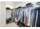 Walk-in closet features ample shelving and hanging space for organized storage of clothing and accessories at 1565 Leaf Ln, Kissimmee, FL 34744