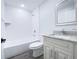 Well-lit bathroom with a tub and shower combo, modern fixtures, and a granite-topped vanity at 1706 3Rd Ave, Deland, FL 32724
