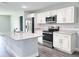 Modern kitchen featuring white cabinets, stainless steel appliances, and granite countertops at 1706 3Rd Ave, Deland, FL 32724