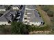 An aerial view of the community featuring similar light exteriors and dark grey roofs, plus some green space at 17459 Chateau Pine Way, Clermont, FL 34711