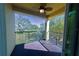Balcony overlooking a green space with trees and plants; ceiling fan included at 17459 Chateau Pine Way, Clermont, FL 34711