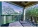 Balcony overlooking a green space with trees and plants; ceiling fan included at 17459 Chateau Pine Way, Clermont, FL 34711