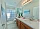 Bathroom with an extended vanity, tile floors, and a shower and tub with a curtain at 17459 Chateau Pine Way, Clermont, FL 34711