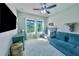 Comfortable bedroom with crib, sofa, dresser, and plenty of natural light from the double windows at 17459 Chateau Pine Way, Clermont, FL 34711