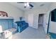 Bedroom with a crib and sofa, a ceiling fan, and plush carpet at 17459 Chateau Pine Way, Clermont, FL 34711