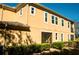 Two-story home with screened-in patio, and manicured hedges at 17459 Chateau Pine Way, Clermont, FL 34711