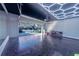 Spacious garage featuring epoxy floors, storage cabinets, and a high-tech ceiling light grid at 17459 Chateau Pine Way, Clermont, FL 34711