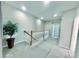Bright hallway features carpet, white railings, and recessed lighting at 17459 Chateau Pine Way, Clermont, FL 34711