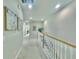 Bright hallway features carpet, white railings, recessed lighting and decorative wall art at 17459 Chateau Pine Way, Clermont, FL 34711
