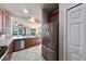 Well-lit kitchen with stainless steel appliances and open layout to the spacious living area at 17459 Chateau Pine Way, Clermont, FL 34711