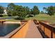 Beautiful lake view featuring a wooden boardwalk and a sandy beach at 17459 Chateau Pine Way, Clermont, FL 34711