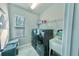 Laundry room with a modern washer and dryer, storage shelves, a utility sink, and a window at 17459 Chateau Pine Way, Clermont, FL 34711