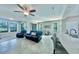 Spacious living room with tile floors, ceiling fan, and bar seating, perfect for entertaining at 17459 Chateau Pine Way, Clermont, FL 34711