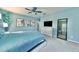 Spacious main bedroom with calming colors, ceiling fan, large dresser, and framed prints for a relaxing ambiance at 17459 Chateau Pine Way, Clermont, FL 34711