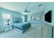 Main bedroom with a large bed, a ceiling fan, and plenty of space for relaxation at 17459 Chateau Pine Way, Clermont, FL 34711