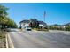 Neighborhood Entrance with landscaped gardens and an American Flag at 17459 Chateau Pine Way, Clermont, FL 34711
