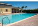 Outdoor community pool and lounge area in a sunny setting at 17459 Chateau Pine Way, Clermont, FL 34711