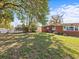 Expansive backyard with lush green grass, mature trees, and privacy fence at 1921 Taylor Ave, Winter Park, FL 32792