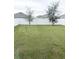 Large backyard features green grass and a white privacy fence, perfect for outdoor activities at 1943 Fountains Dr, Kissimmee, FL 34744