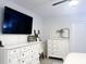 Nicely styled bedroom with dresser, mounted TV, and modern ceiling fan at 1943 Fountains Dr, Kissimmee, FL 34744