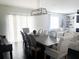 Dining room featuring a long wooden table, neutral chairs, modern chandelier, and bright lighting at 1943 Fountains Dr, Kissimmee, FL 34744