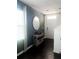 Welcoming entryway featuring dark floors, a round mirror, and an accent table at 1943 Fountains Dr, Kissimmee, FL 34744