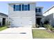 Charming two story home featuring blue shutters and a well maintained front lawn at 1943 Fountains Dr, Kissimmee, FL 34744