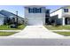 Two story home showcasing a long driveway, green shutters, and a well maintained lawn at 1943 Fountains Dr, Kissimmee, FL 34744
