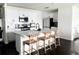 Bright kitchen with white cabinets, stainless steel appliances, and barstool seating at the center island at 1943 Fountains Dr, Kissimmee, FL 34744