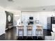 Bright kitchen with white cabinets, stainless steel appliances, and barstool seating at the center island at 1943 Fountains Dr, Kissimmee, FL 34744