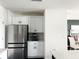 Kitchen area featuring stainless steel appliances, white cabinets, and open layout at 1943 Fountains Dr, Kissimmee, FL 34744