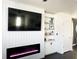 Living room featuring a modern fireplace, built-in shelving, and stylish decor at 1943 Fountains Dr, Kissimmee, FL 34744