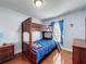 Cozy bedroom featuring wooden bunk beds, wood floors, and a dresser, perfect for  at 2316 Paulette Dr, Haines City, FL 33844